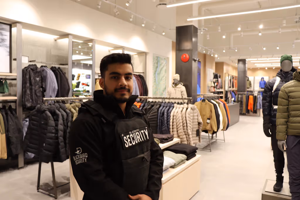 Retail security guard wearing a vest in a clothing store