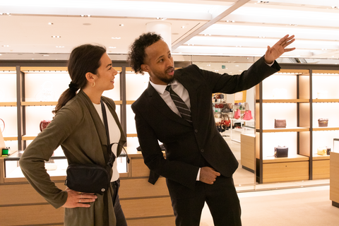 Plained Clothes Blackbird security guard in retail location speaking with woman