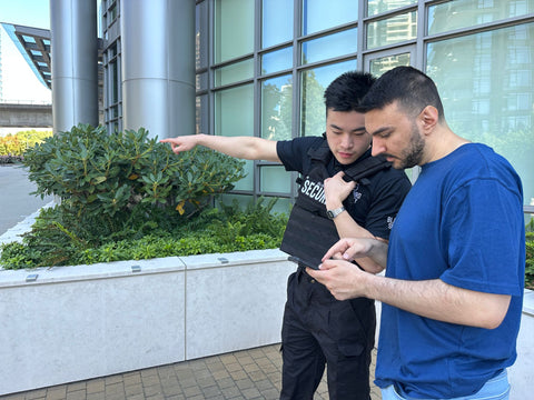 Uniformed Blackbird security guard speaking to man and giving directions