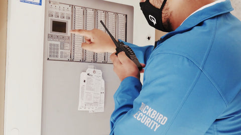 Blackbird Security guard at control panel with radio