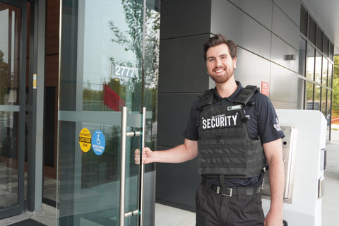 Uniformed Blackbird security guard opening door