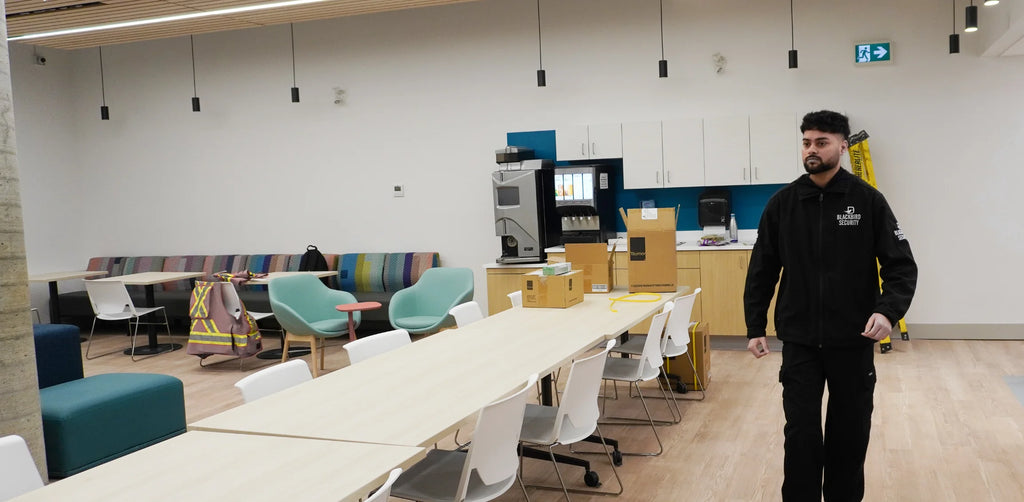 A Blackbird Security guard patrols an indoor common area at Covenant House Vancouver