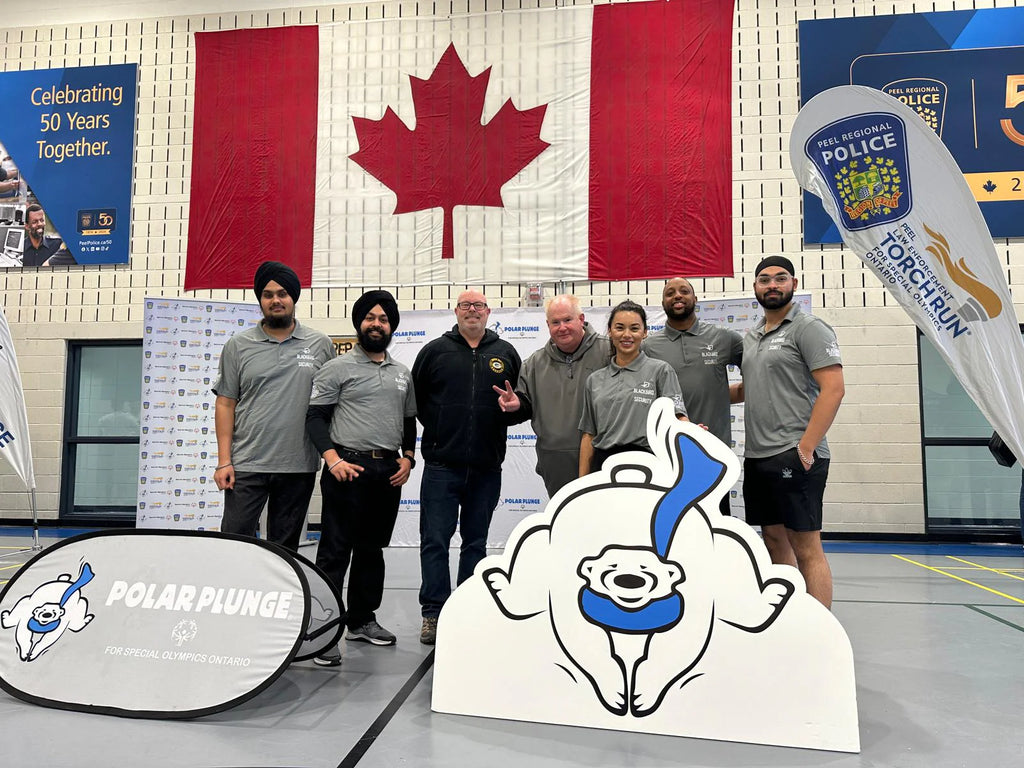 The Blackbird Security team stands with York Regional Police in a gym during the Polar Plunge event