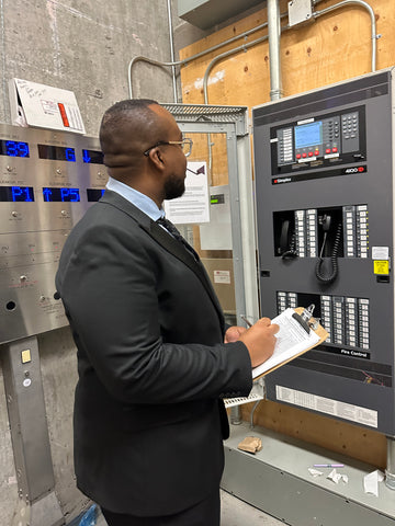 Blackbird Security guard looking a security control systems with clipboard in hand