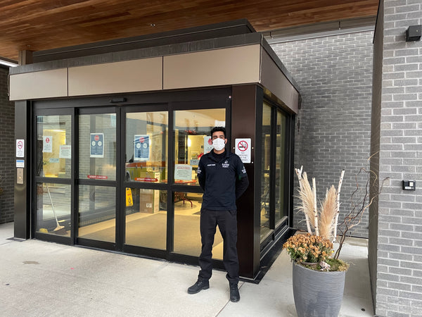 Uniformed Blackbird security guards standing in front of building