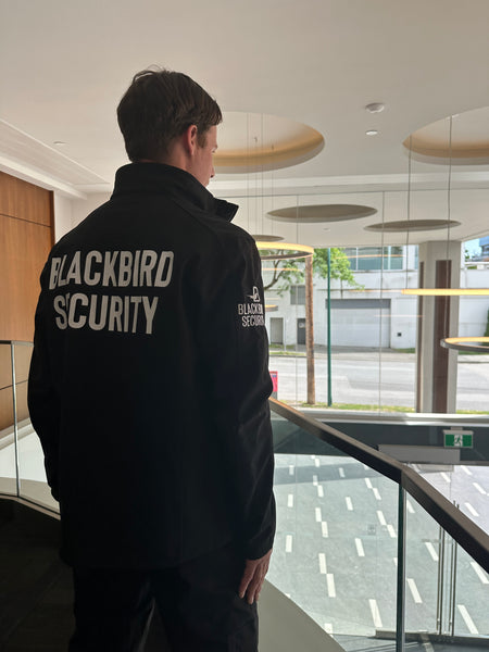Uniformed Blackbird security guard patrolling office building