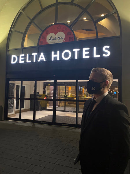 Uniformed Blackbird security guards standing in front of Delta hotel
