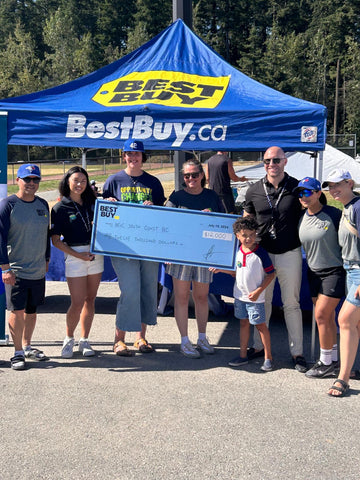Group of people holding big cheque