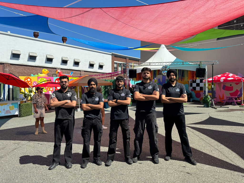 Five Blackbird Security event security guards stand in a line, facing the camera, conducting event security in Vancouver at The Birdhouse during Pride weekend.