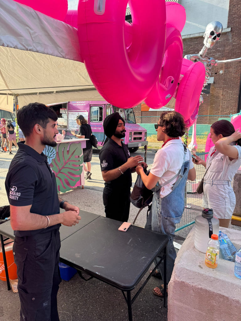 A Blackbird Security guard checks bags at Birdhouse event in Vancouver during Pride weekend.