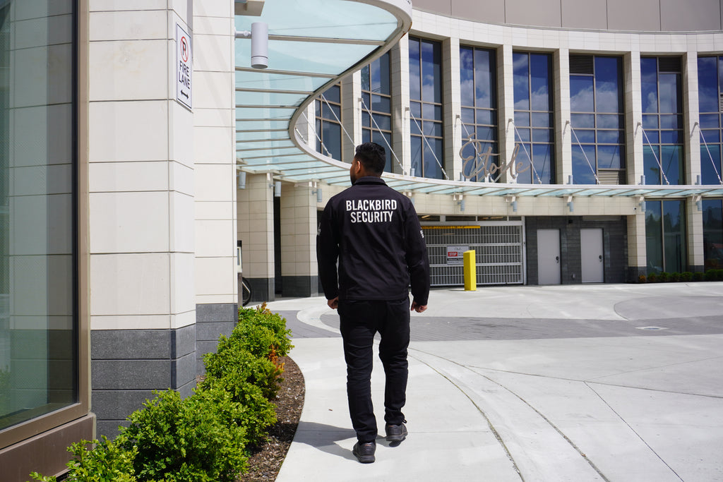 Condo security guard patrols the exterior of a residential building.