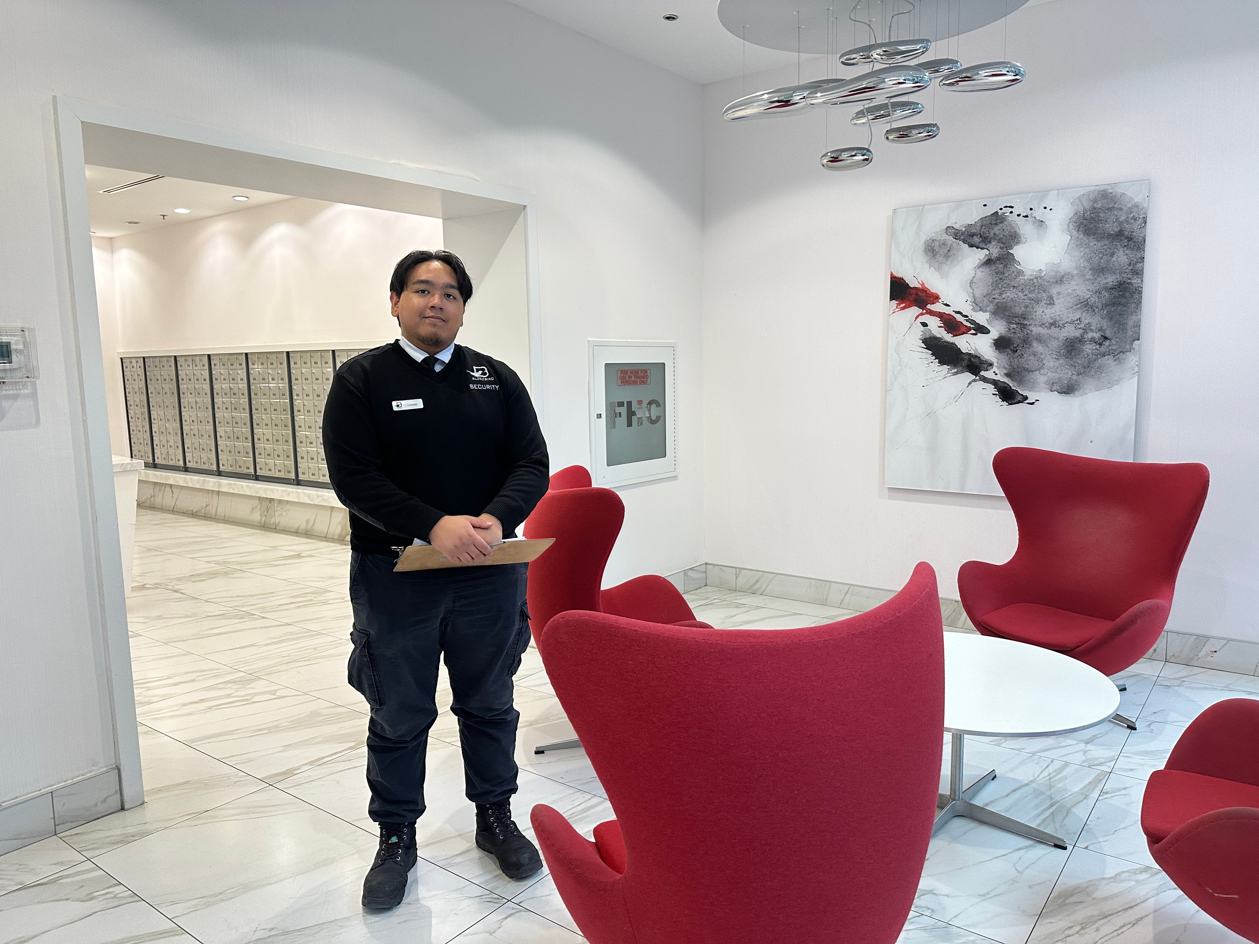 Blackbird Security guard standing in a building lobby