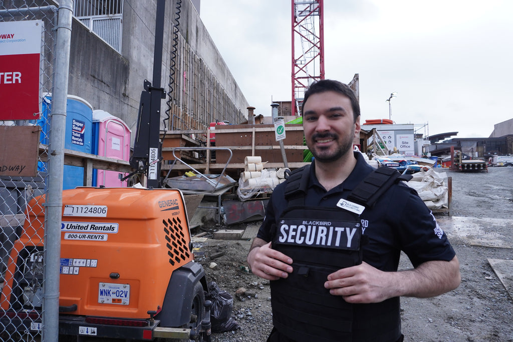 A Blackbird Security guard on a construction site facing the camera.