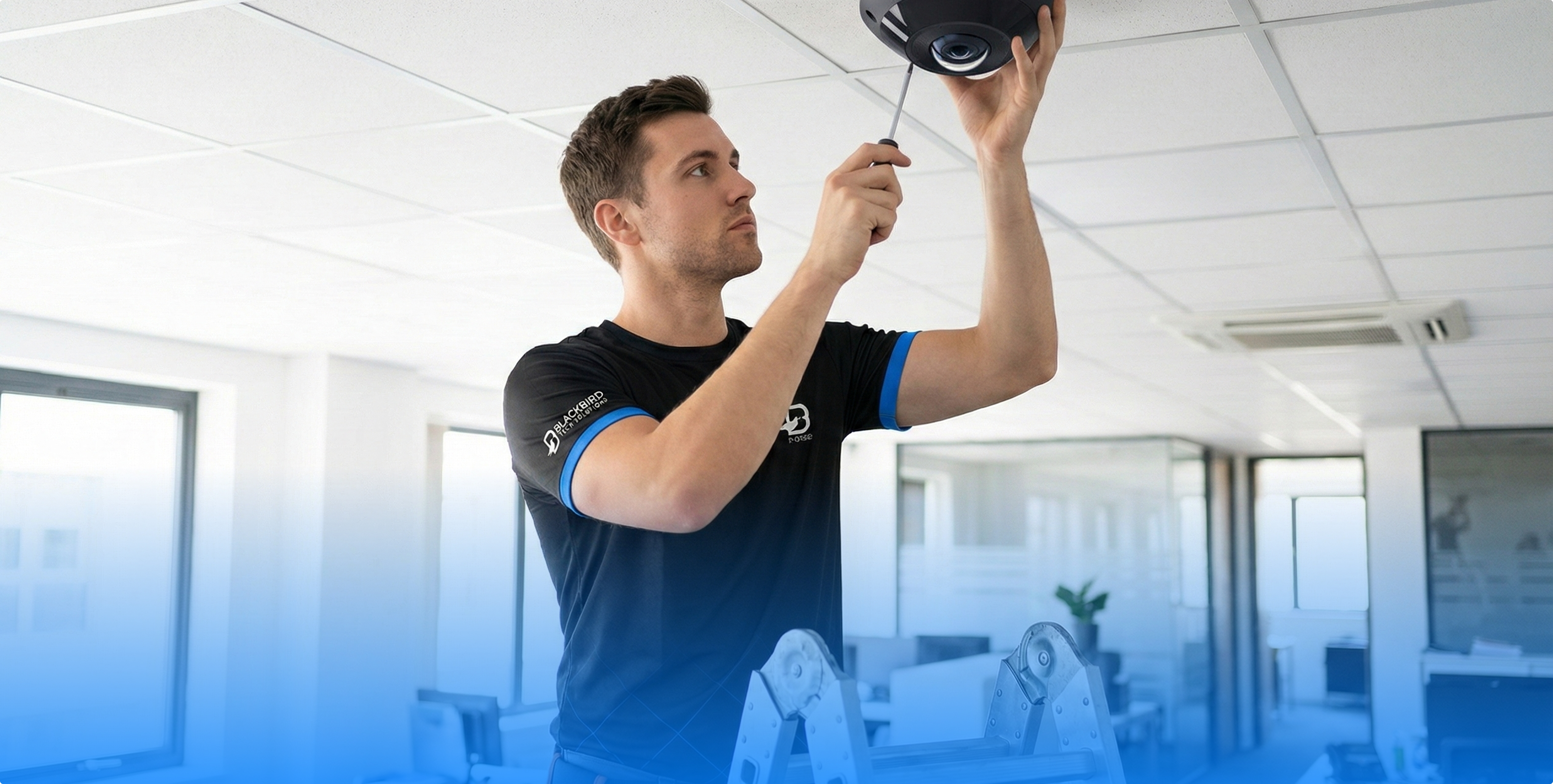 Blackbird technician installing camera in office