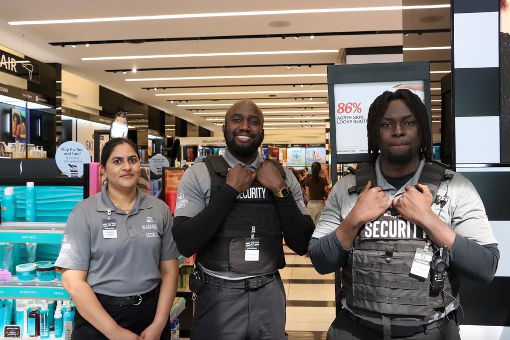 3 retail security guards standing inside a Sephora store.
