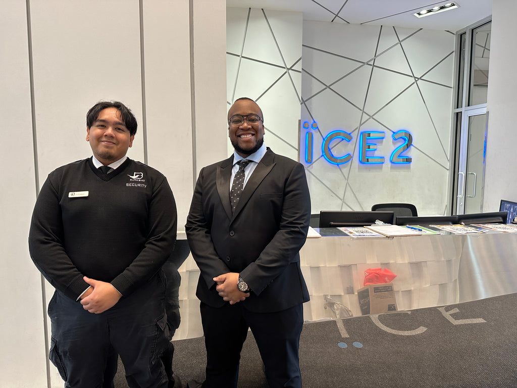 Two Blackbird Security professionals standing in building reception