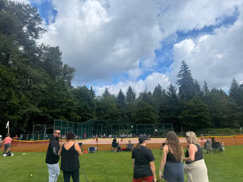 people standing in front of baseball diamond