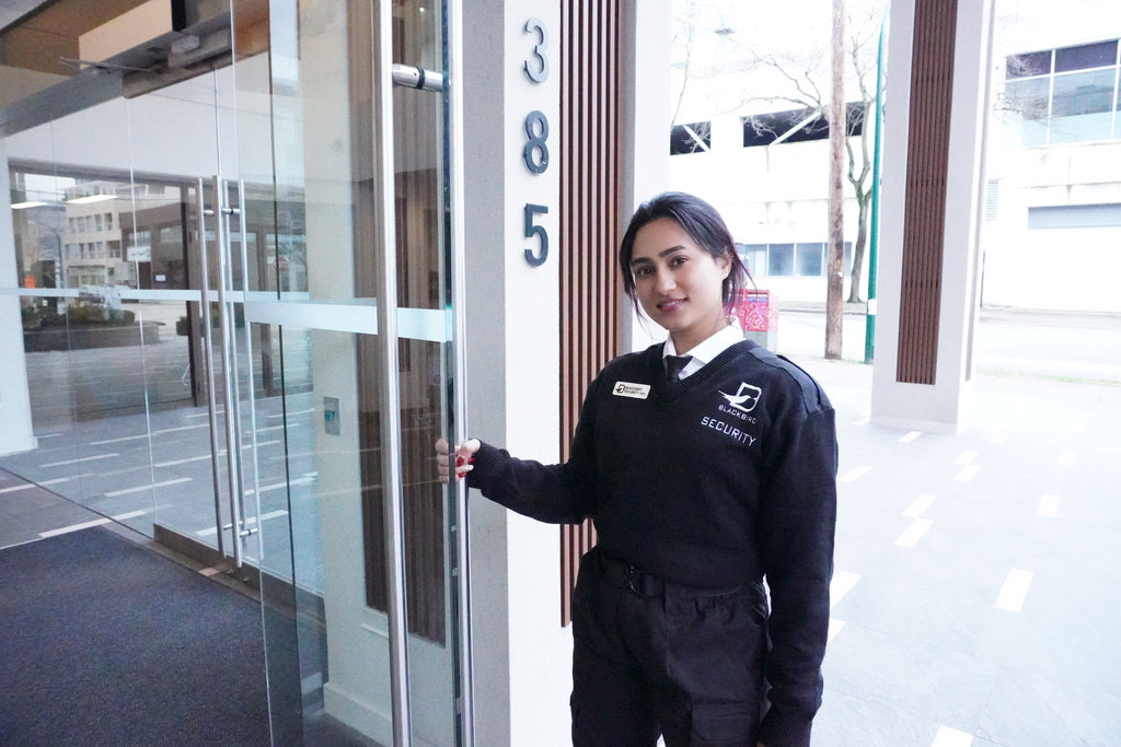 A Blackbird Security guard opens the door to a corporate office building