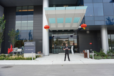 Uniformed Blackbird security guards standing in front of building