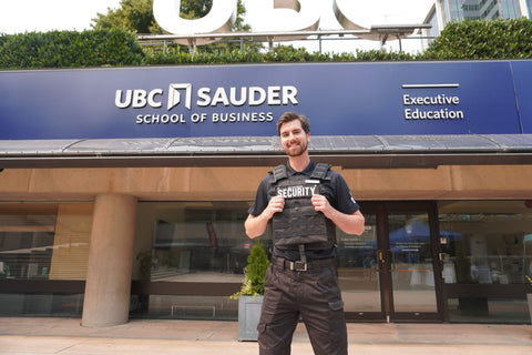 Uniformed Blackbird security guard standing outside UBC Saunders School of Business
