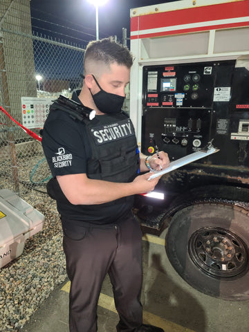 Uniformed Blackbird security guard standing in generator with clipboard