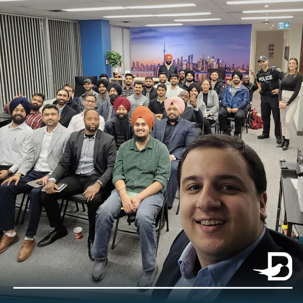 Blackbird Security training leader Amir Anvarizadeh taking a selfie in front of a crowd of an audience
