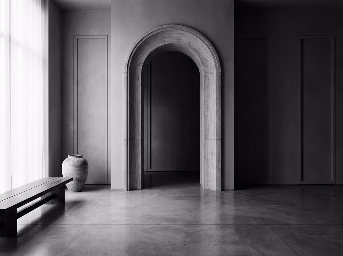 Minimalist interior featuring an arched doorway with stone trim, a wooden bench, and a large ceramic vase next to a window with sheer curtains.