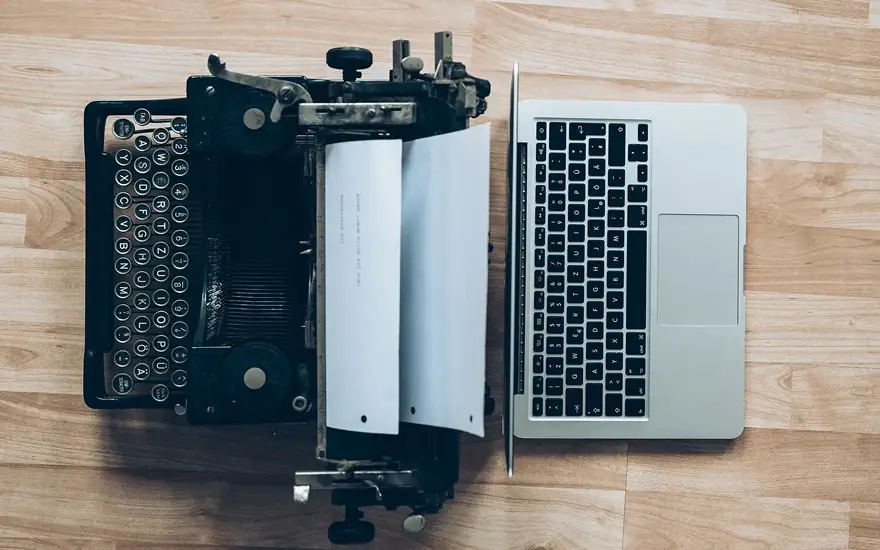 Photo of typewriter and laptop side by side