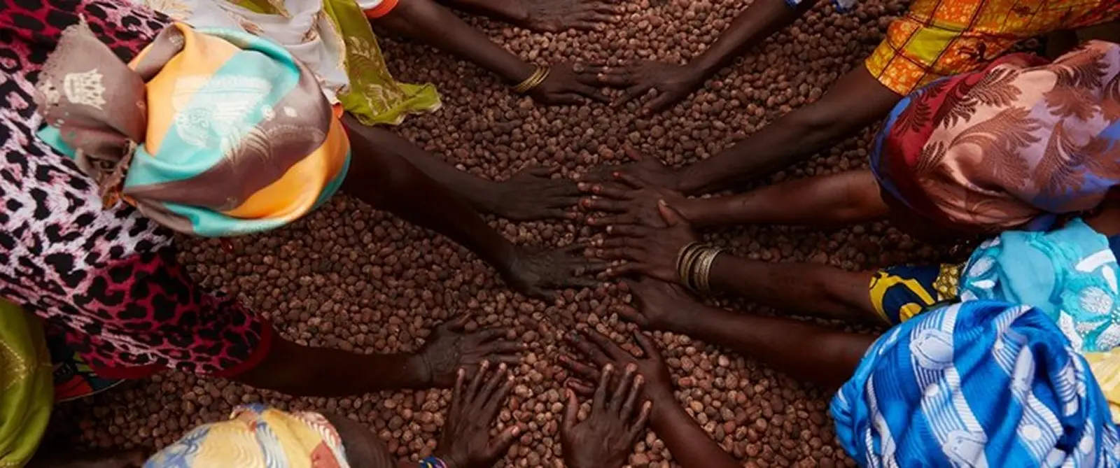 Body Shop - women working to make shea butter