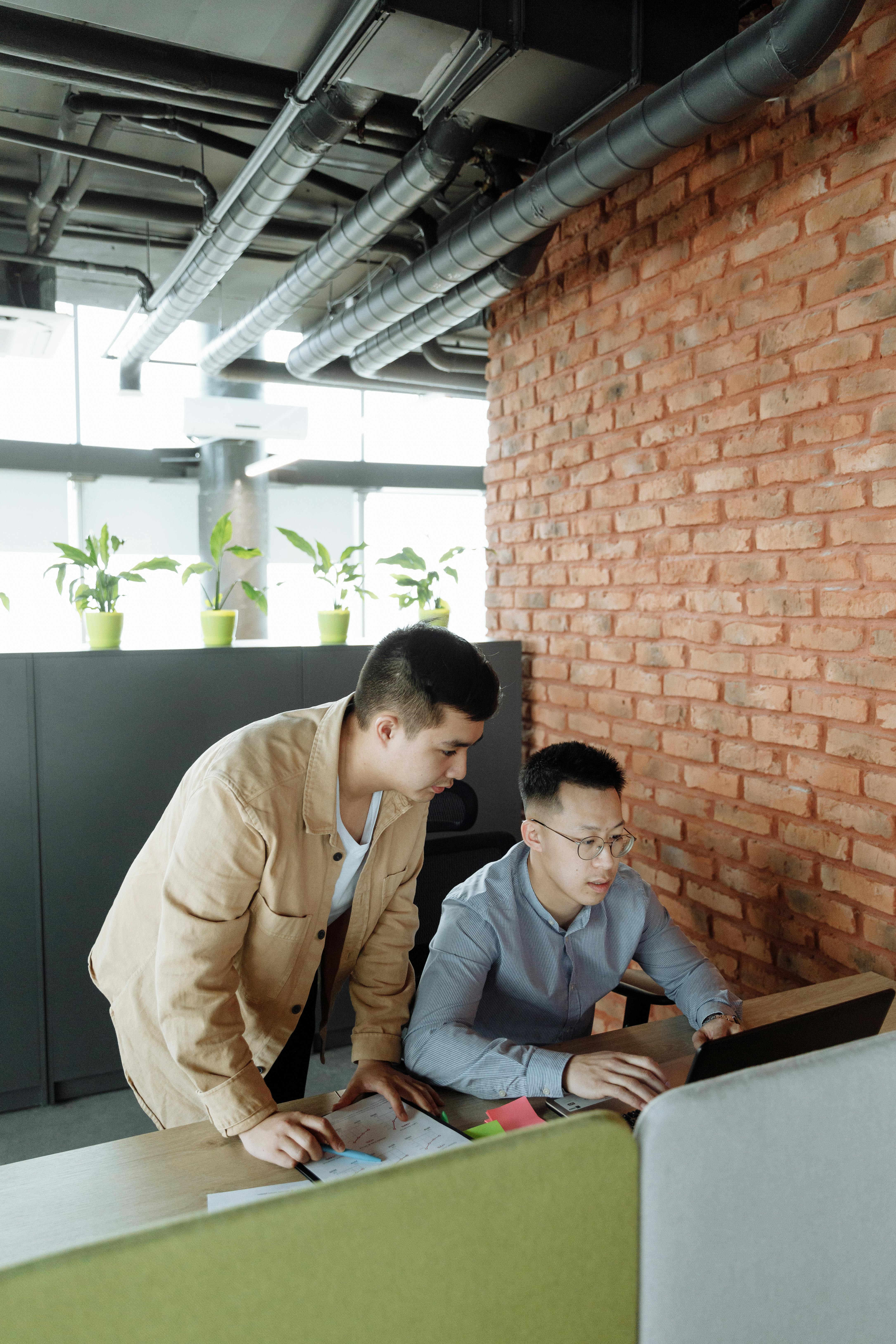 Two colleagues reviewing a document together at a desk