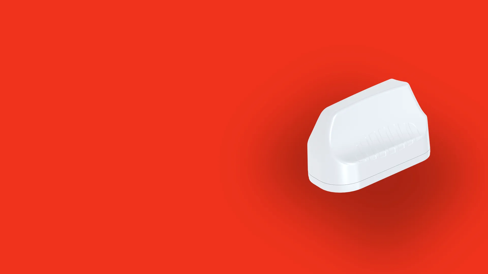 White compact electronic device with a curved top and ribbed indentation on a bright red background.