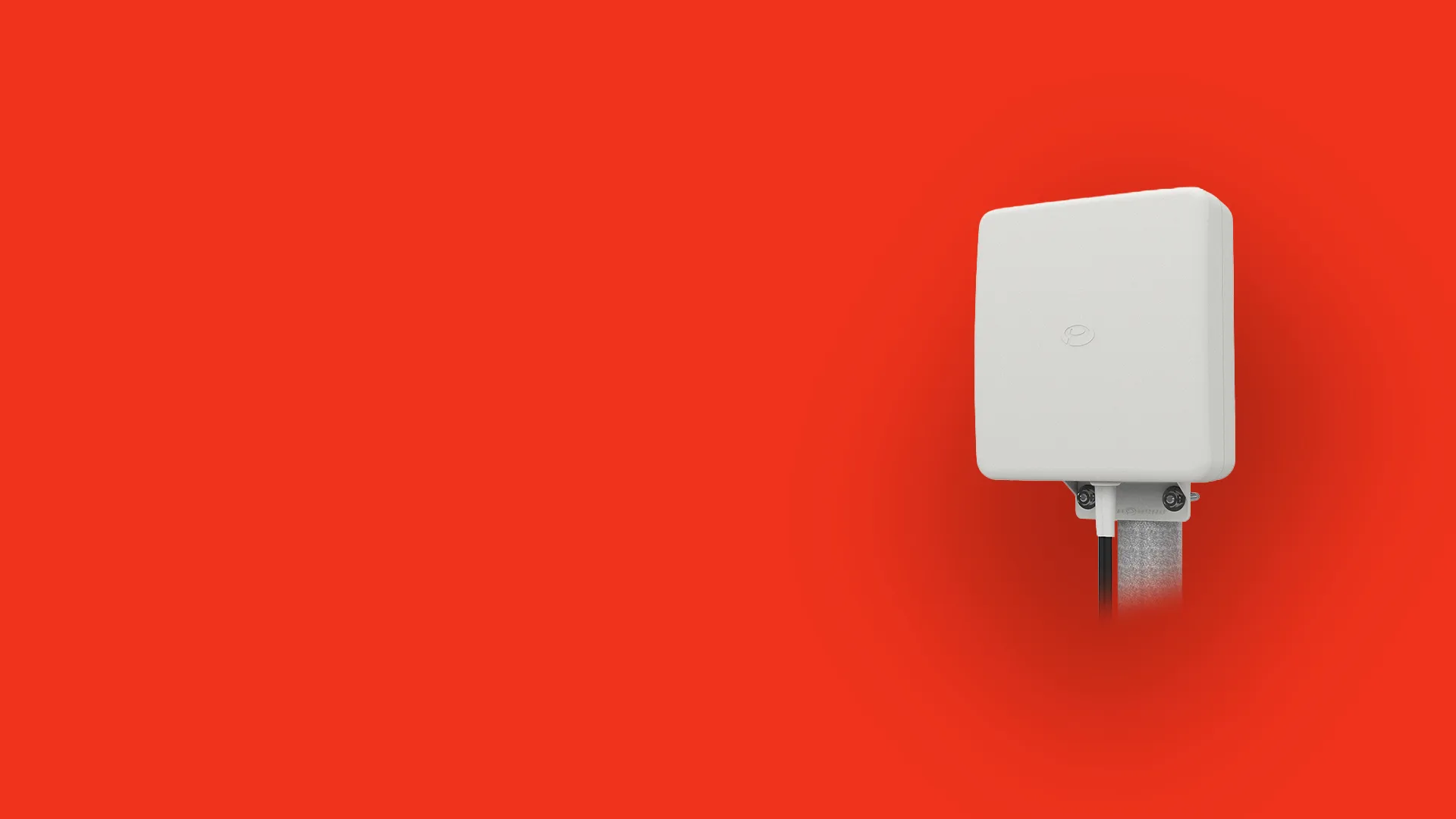 Small, white, square electronic device mounted on a metal pole against a solid red background.