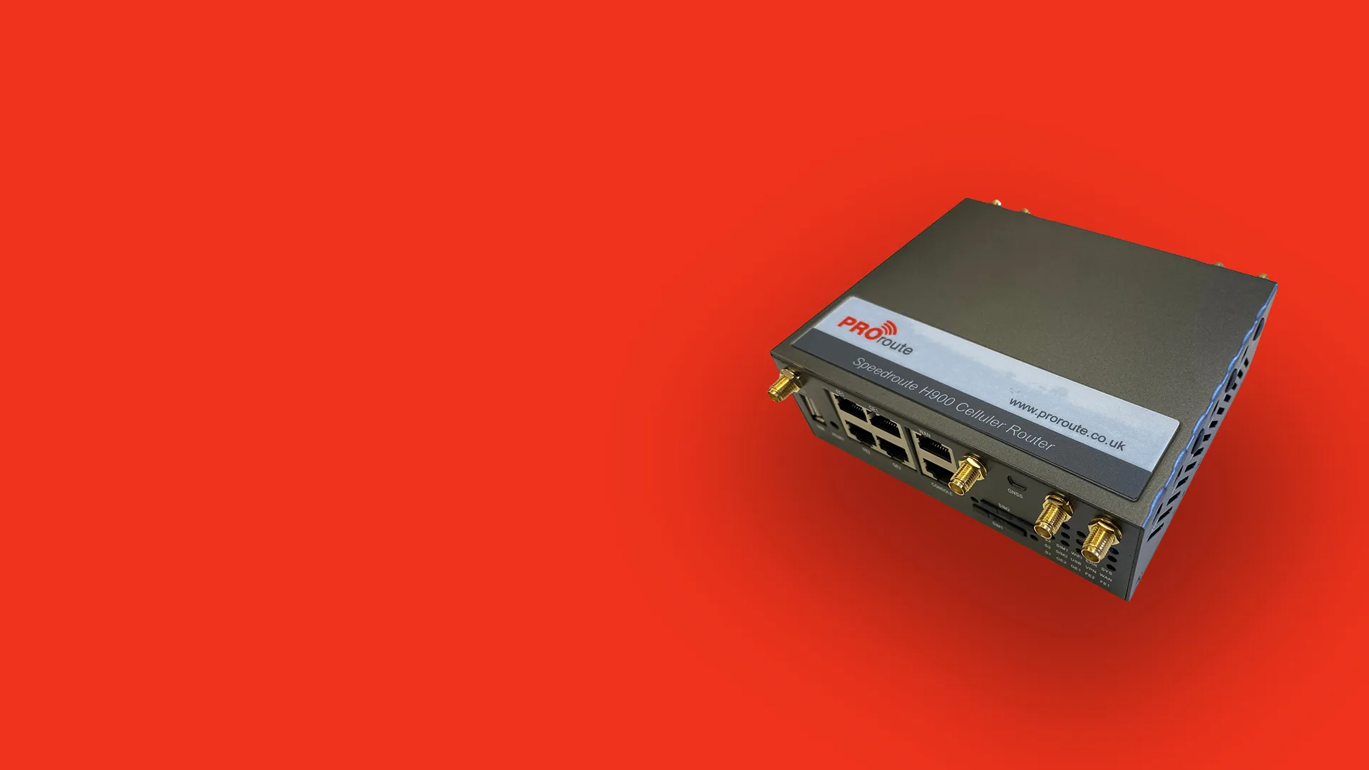 ProRoute Speedroute H900 cellular router with multiple Ethernet ports and antenna connectors on a red background.