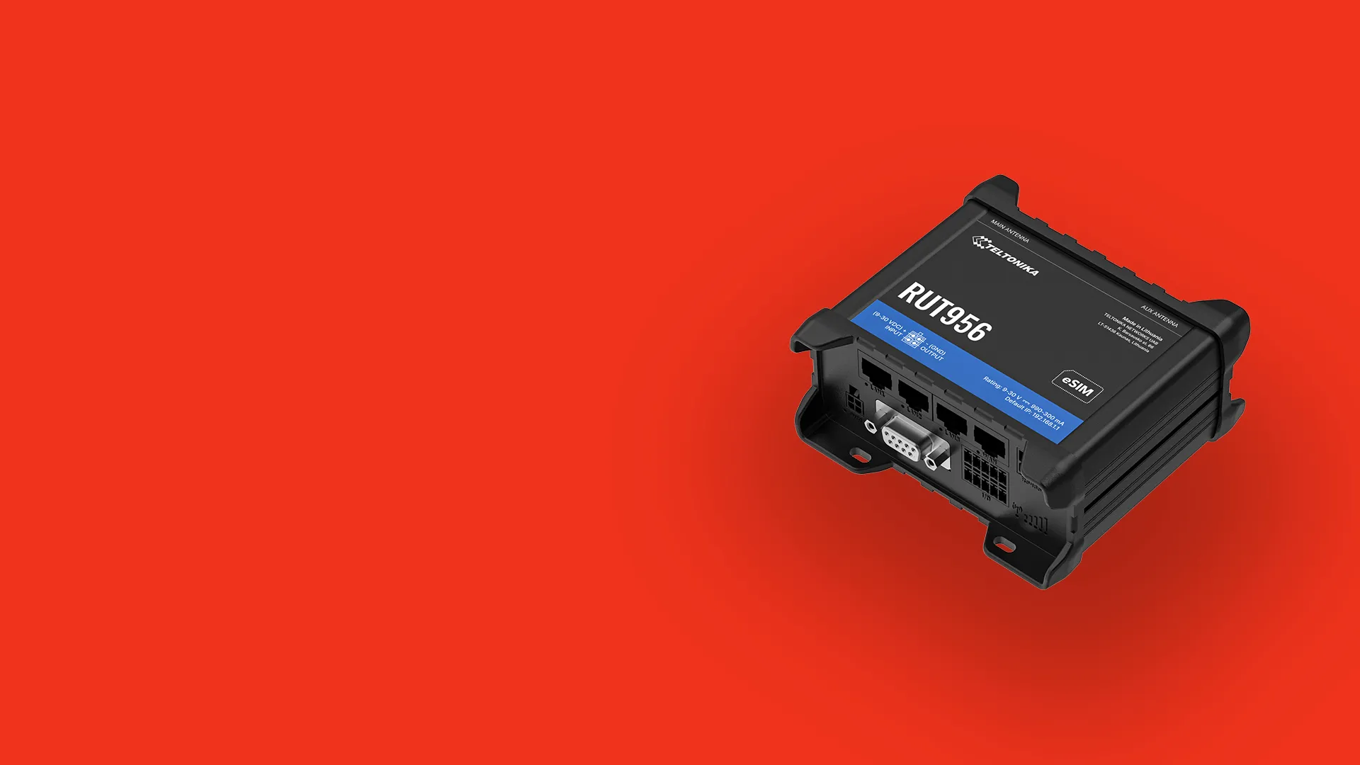 Teltonika RUT956 black industrial cellular router device on a red background.