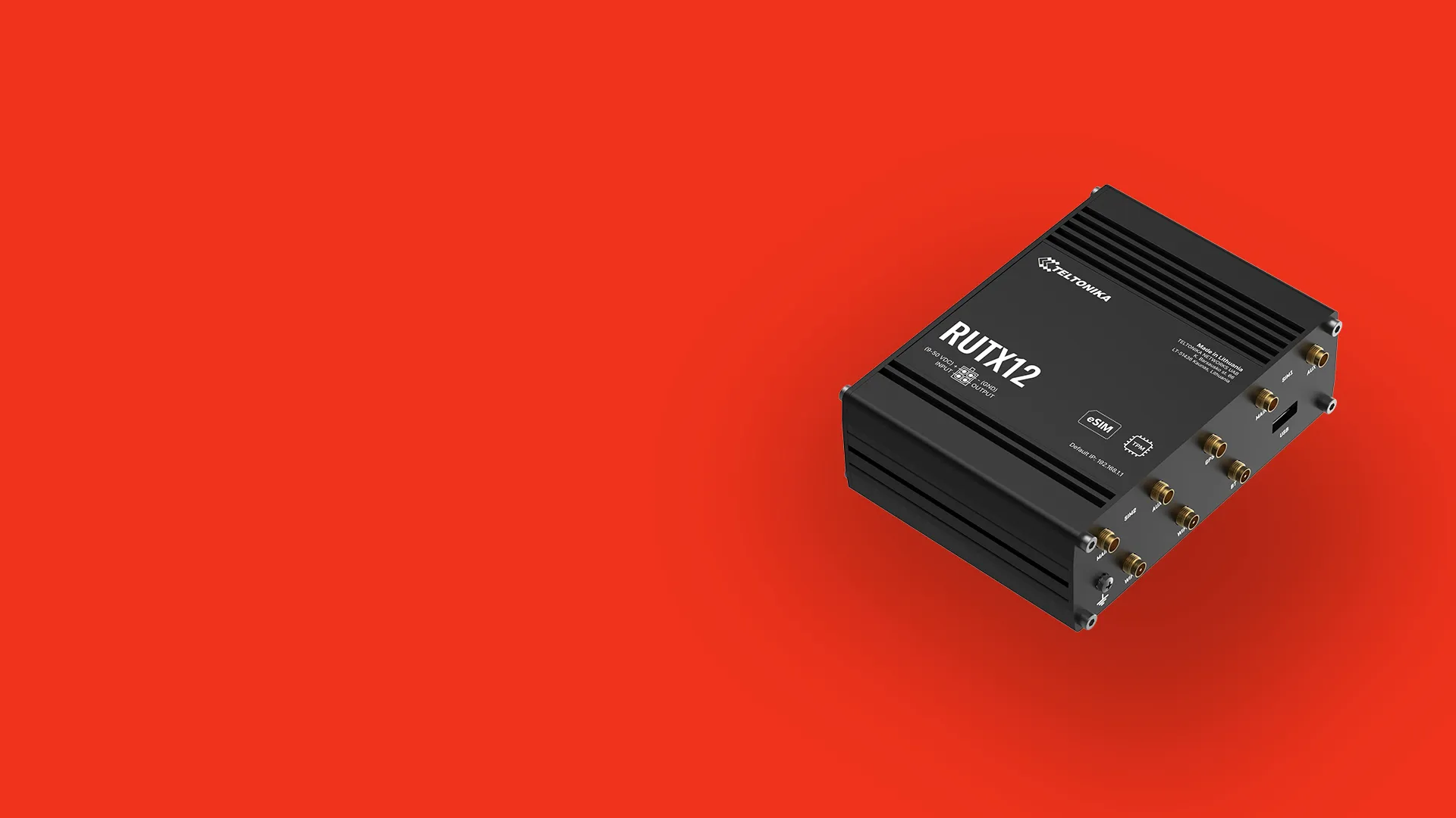 Black Teltonika RUTX12 industrial cellular router on a red background.