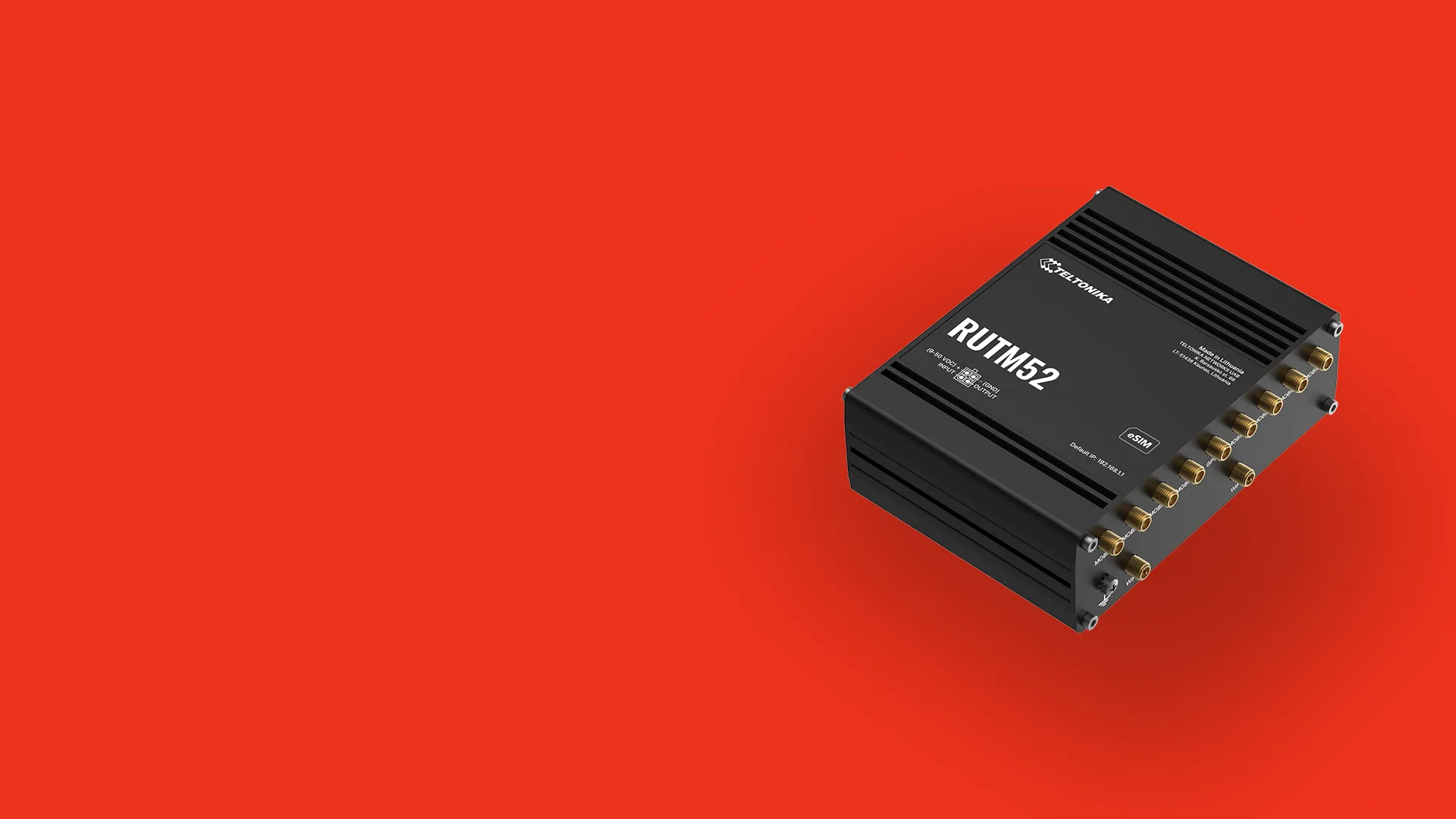 Black Teltonika RUTM52 industrial router with multiple antenna ports on a red background.