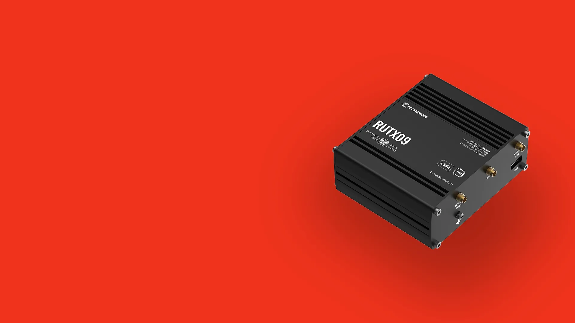 Black Teltonika RUTX09 LTE router on a red background.
