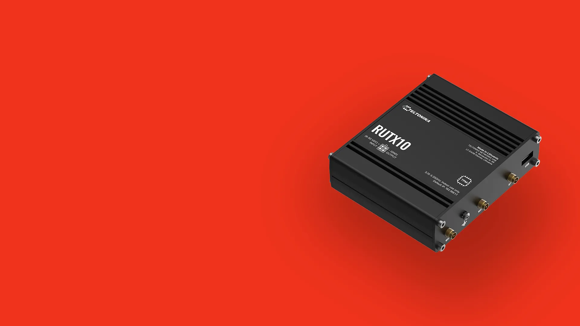 Black Teltonika RUTX10 industrial router with multiple antenna connectors on a red background.