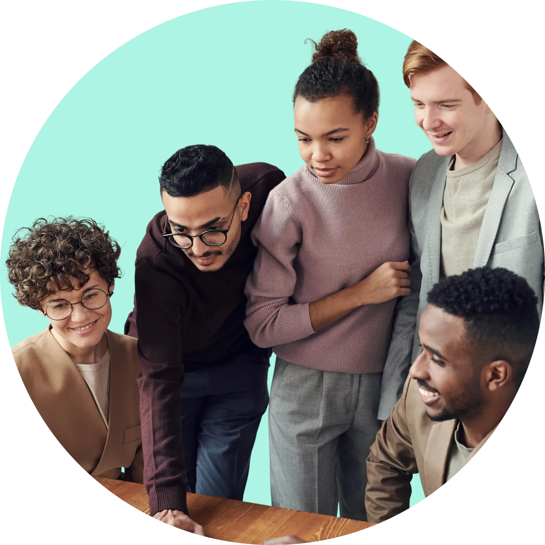 A diverse group of people looking at the laptop