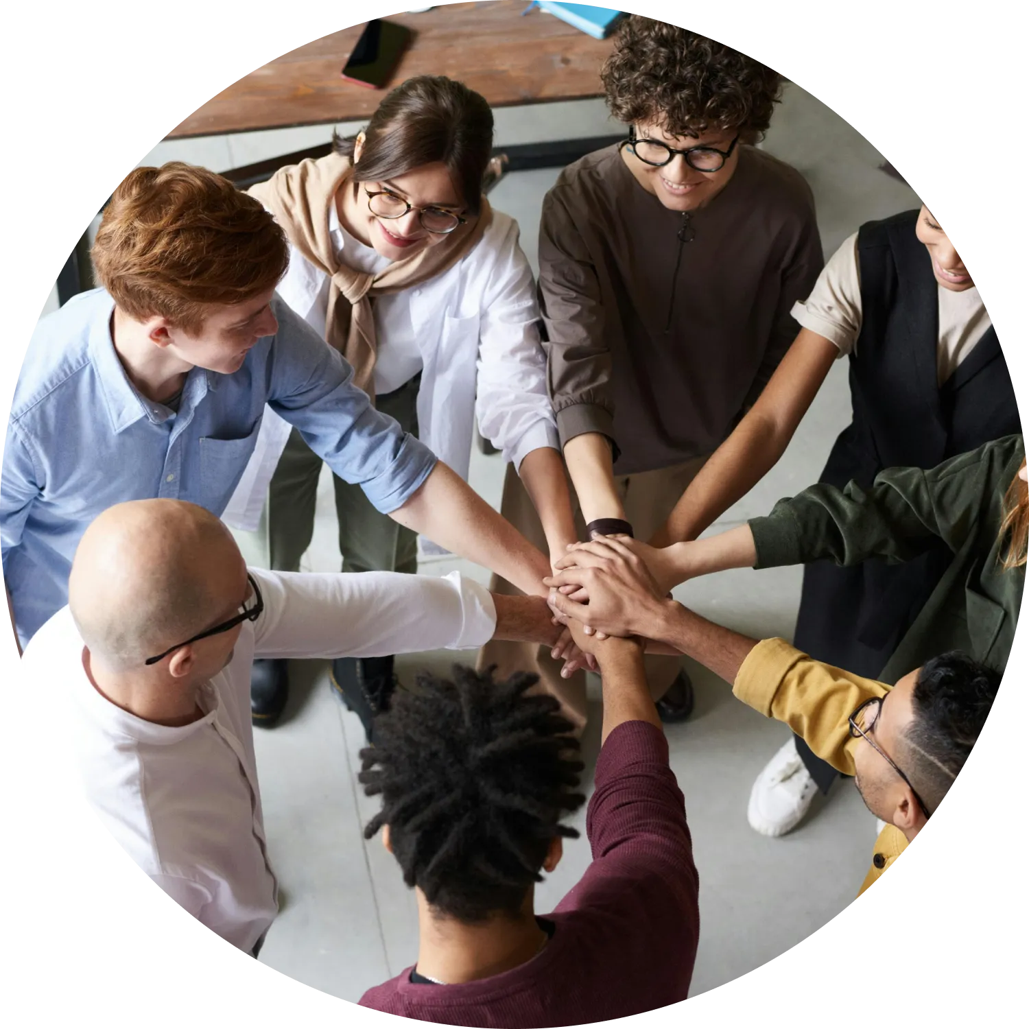 A diverse group of people looking at the laptop