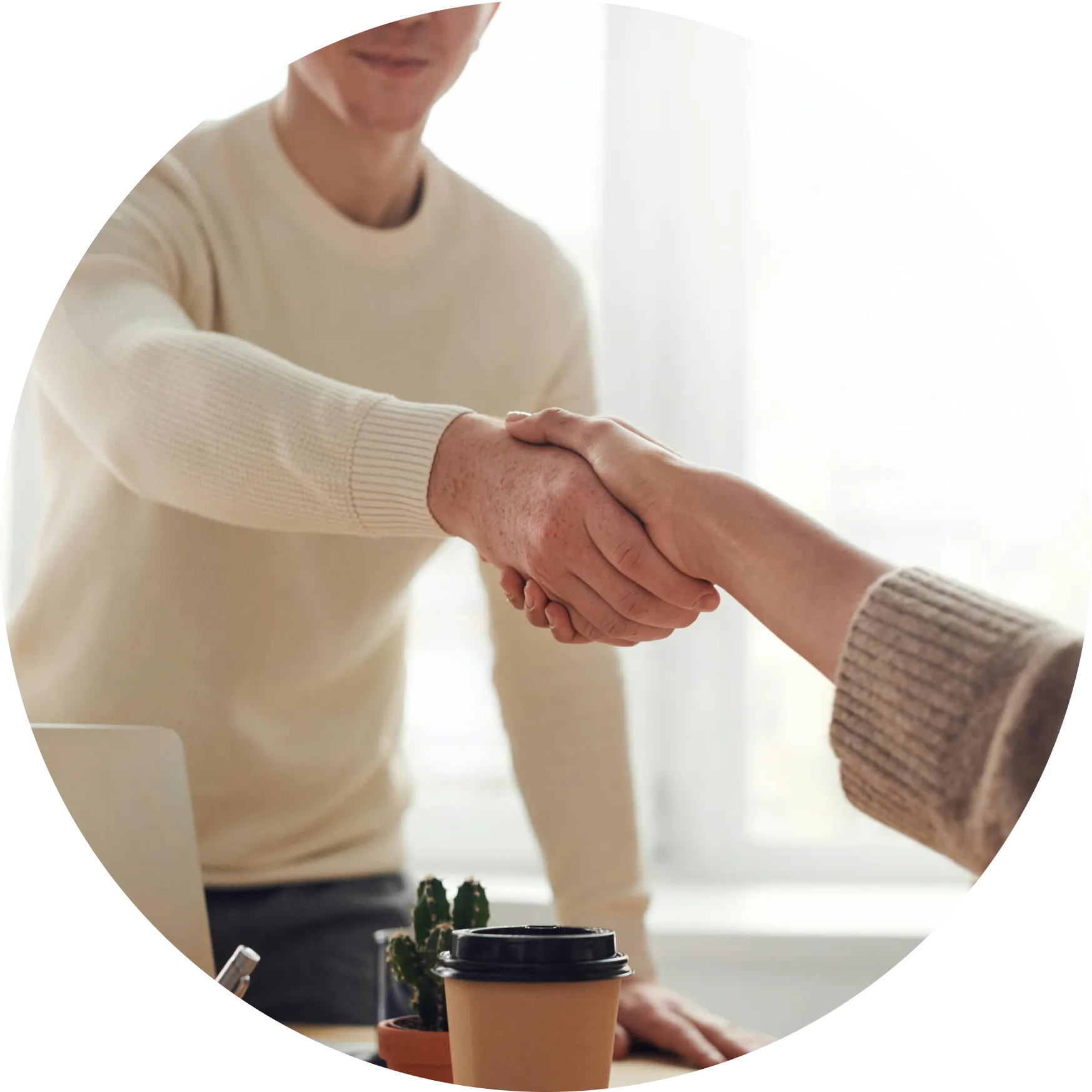 A diverse group of people looking at the laptop
