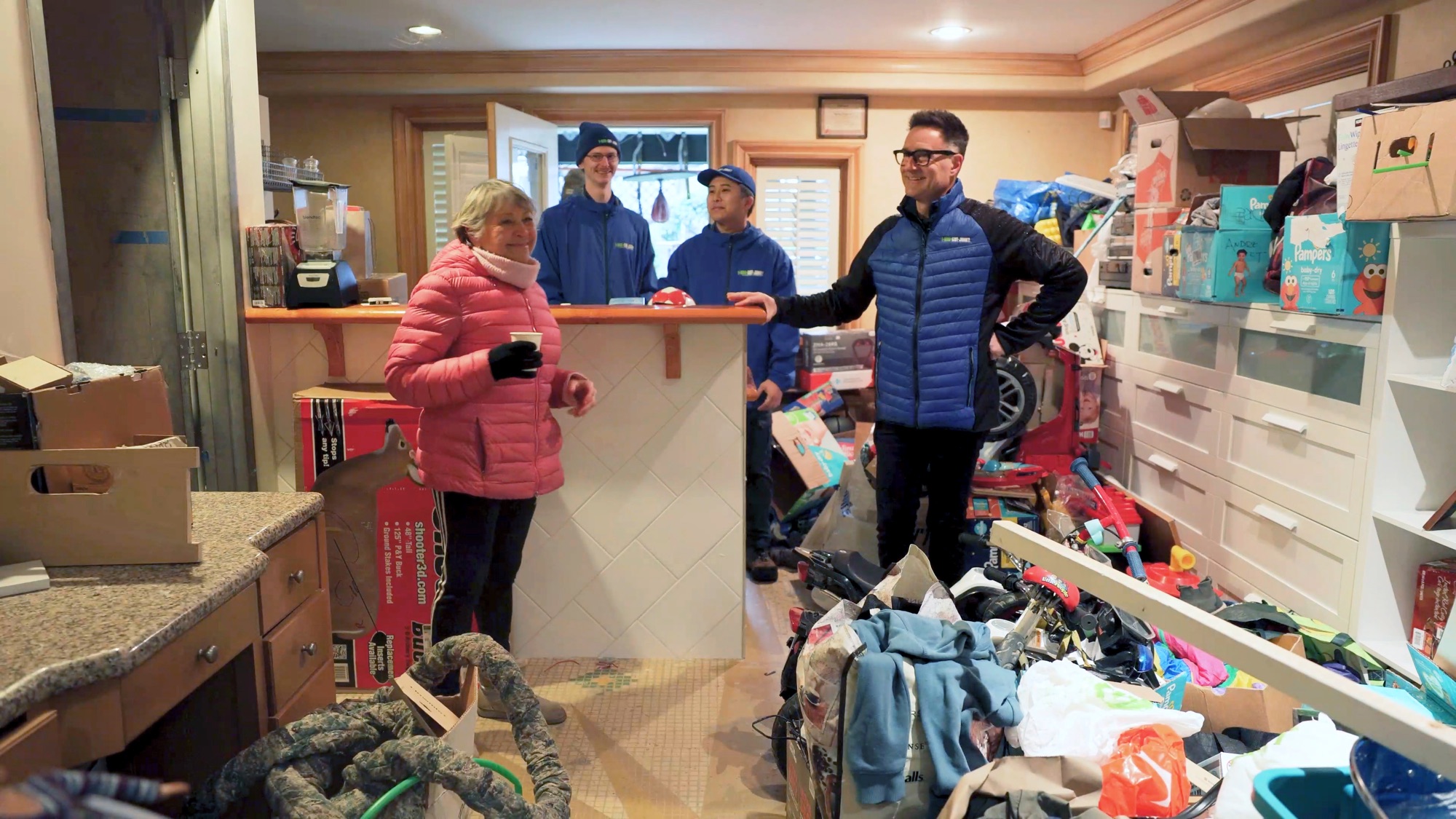 1-800-GOT-JUNK? team members carrying furniture out of a home during an estate cleanout