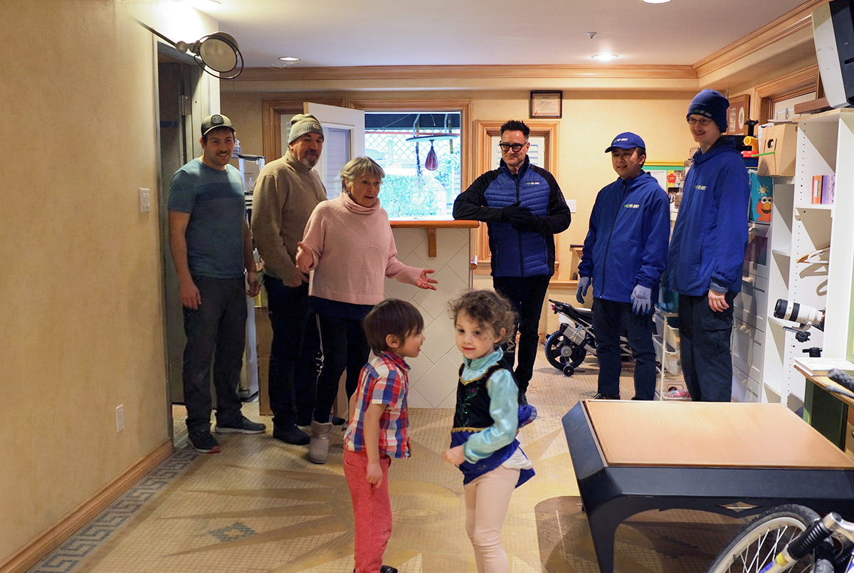 Brian Scudamore and 1-800-GOT-JUNK? team members talking with a homeowner during a cleanout