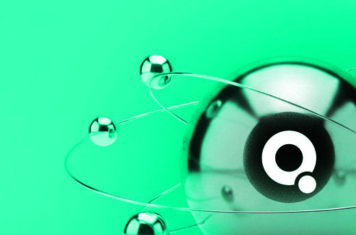 Abstract metallic spheres with one central sphere featuring a white circular logo on a green background.