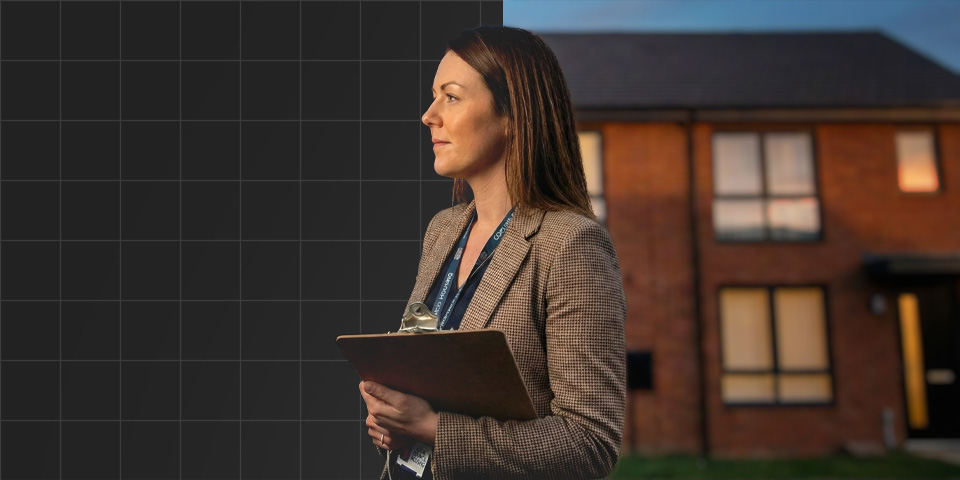 Woman in business attire holding a clipboard standing outside a house.
