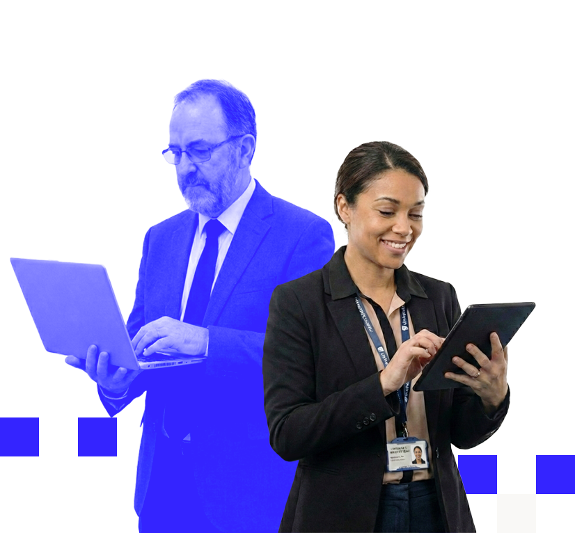 Smiling woman in business attire using a tablet with a man in a suit holding a laptop in the background.