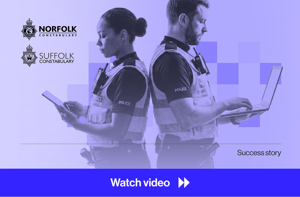 Two police officers from Norfolk and Suffolk Constabulary stand back to back, one reading a tablet and the other using a laptop, with text 'Success story' and a blue button labeled 'Watch video'.
