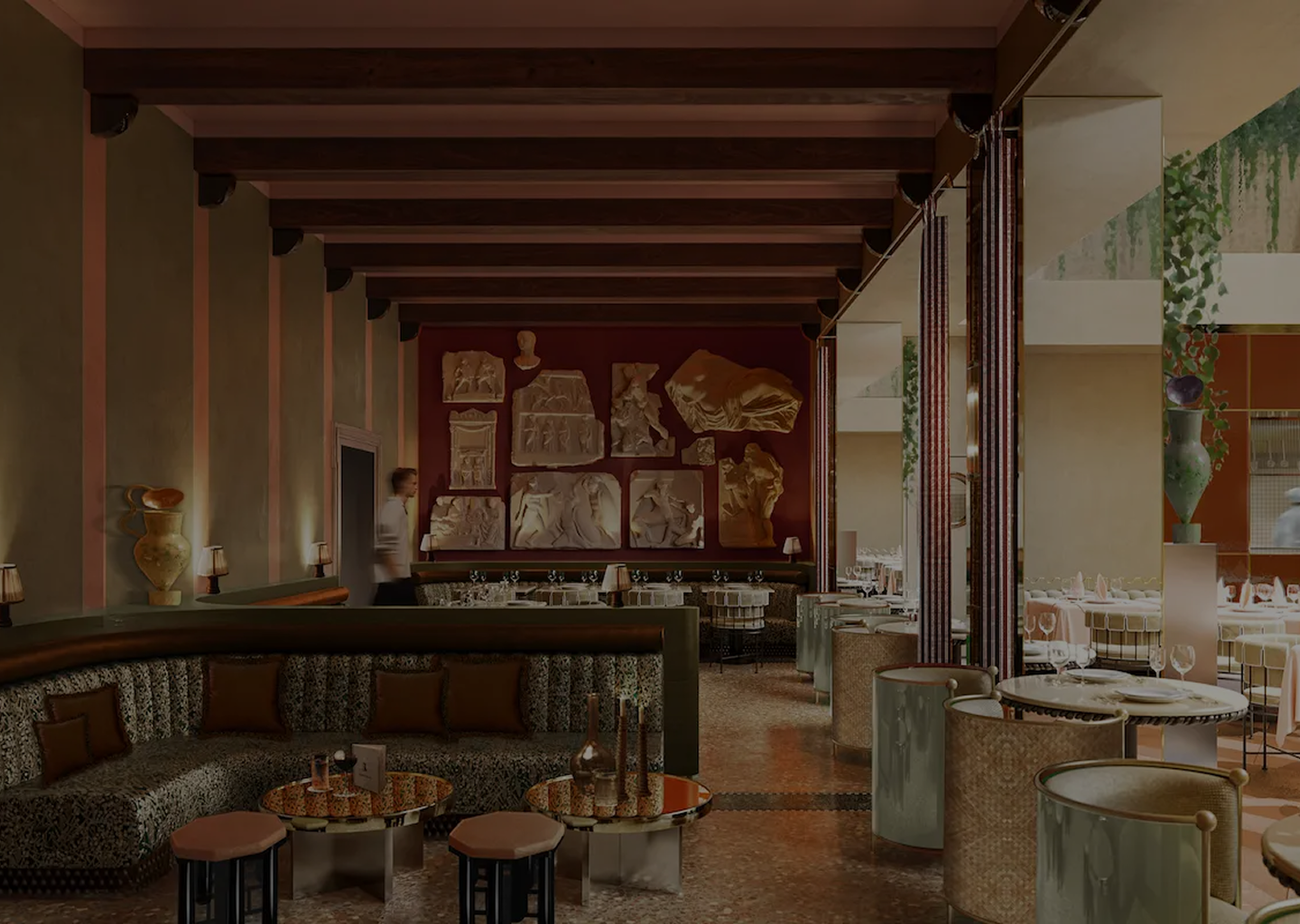 Elegant restaurant interior with patterned sofas, round tables, spaced seating, wall-mounted classical relief sculptures, and warm lighting.