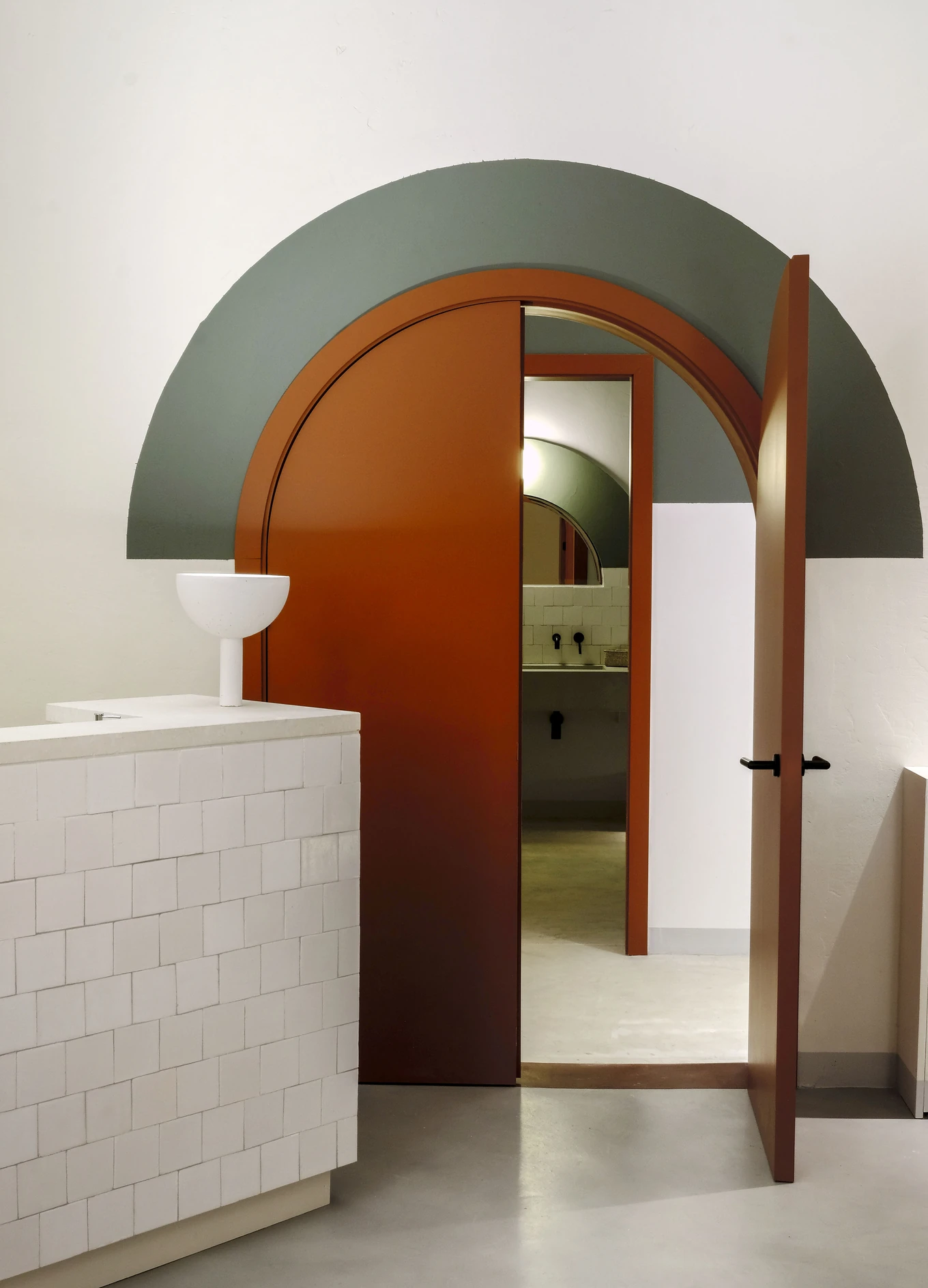 Interior design detail with arches and colorful door at Hotel Le Garage, Biarritz.