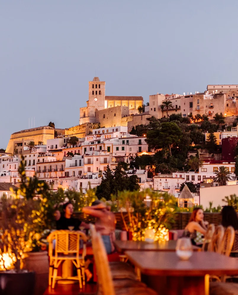 Cozy atmosphere on the terrace of an Experimental Group hotel at sunset, panoramic view over the old town.
